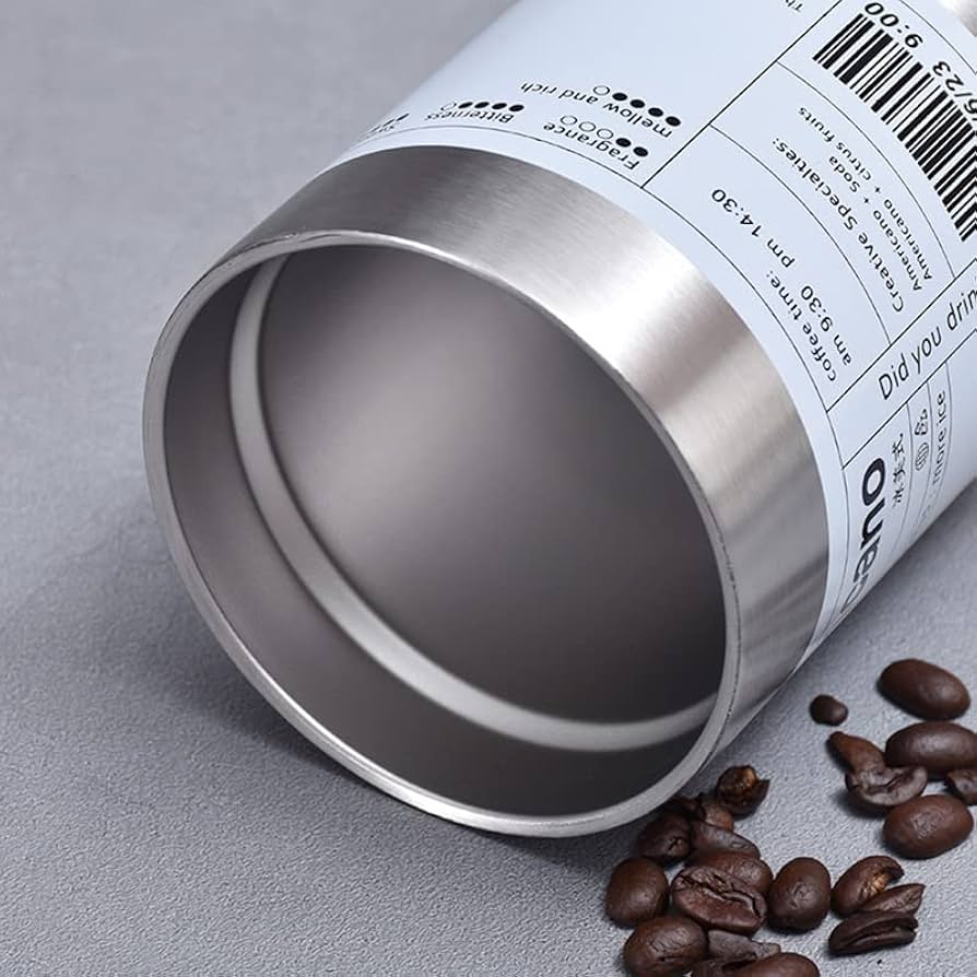Clarify.pk stainless steel coffee tumbler showing open top with coffee beans nearby on gray surface