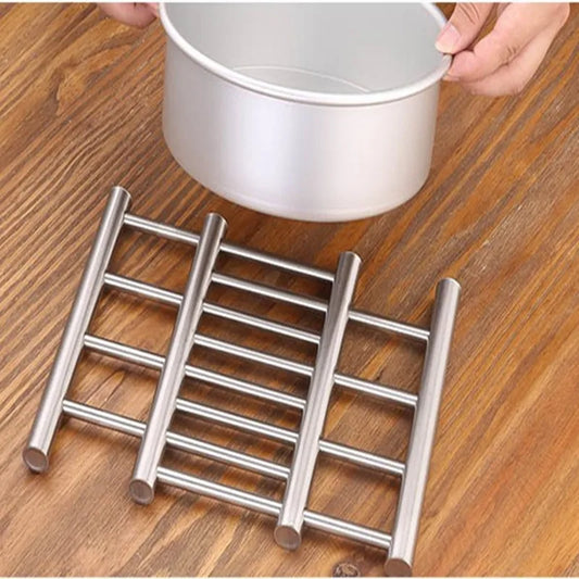 Clarify.pk stainless steel heat insulated rack on wooden surface with pot being placed on it