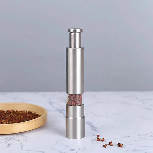 Clarify.pk stainless steel pepper grinder with sleek design and clear spice container on marble surface