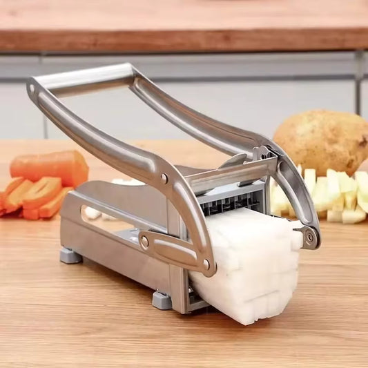 Stainless steel potato cutter slicing a white potato into even cubes on a wooden countertop