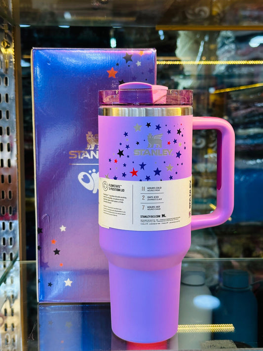 Purple insulated tumbler with straw by Stanley featuring star design and a handle