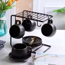 Stylish coffee mugs holder by Clarify.pk with black cups hanging and plates on a white countertop
