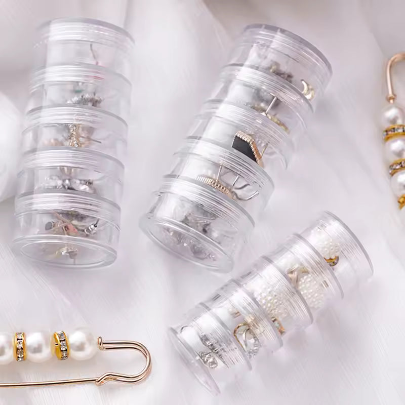 Clear 5 layer jewelry storage box by Clarify.pk holding various earrings and small accessories