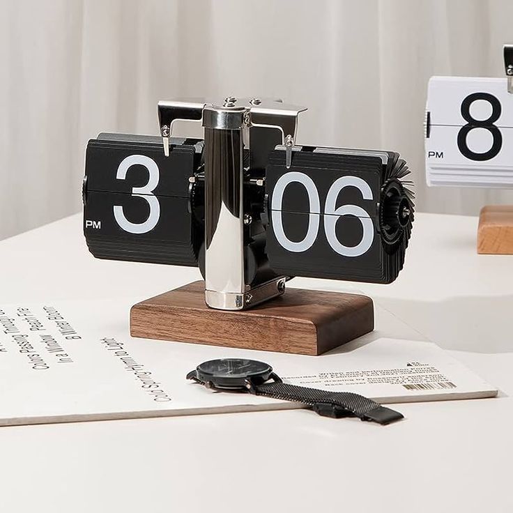 retro flip desk clock black chrome mechanism on walnut wooden base showing 3 06 PM on minimalist desk