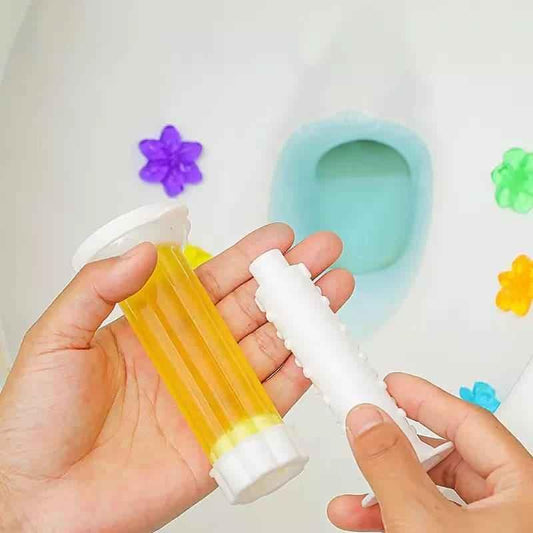 Hands holding a yellow Toilet Fragrance Gel Injection near a clean toilet bowl with colorful flower decorations
