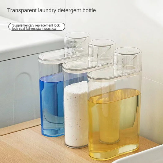 Set of three transparent laundry detergent dispenser bottles filled with blue, white, and yellow detergent liquids on a wooden surface
