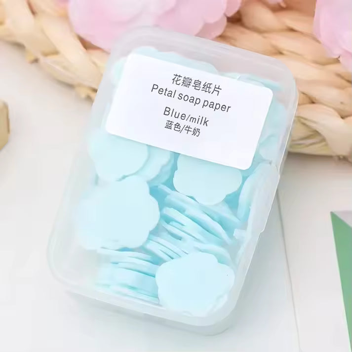 Clarify pk travel soap paper sheets in blue milk color shaped like petals in a clear plastic container
