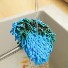 Triangle wall cleaning mop cloth cover in blue and green microfiber strands under running water