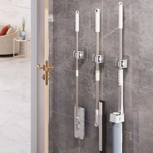 Clarify.pk broom mop wall clips holding cleaning tools on a gray tiled wall in a modern home