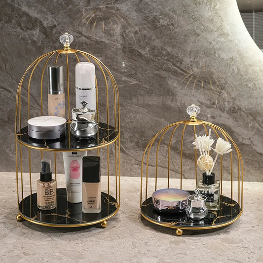 Clarify.pk 2 tier cosmetic storage rack with gold frame and black marble shelves holding makeup products