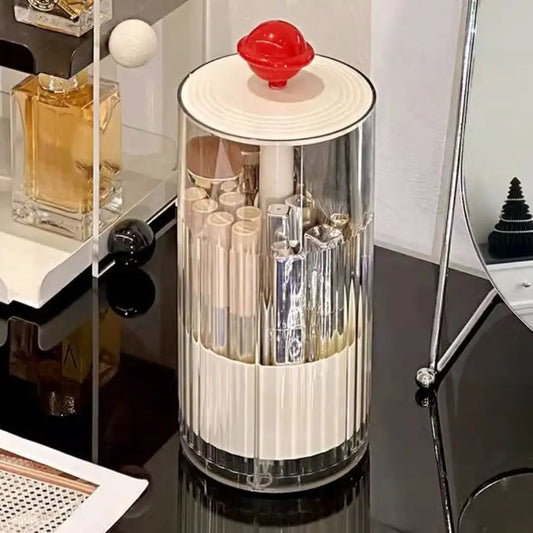 Clarify.pk dustproof makeup brush holder with transparent cylindrical design and red lid on black vanity table