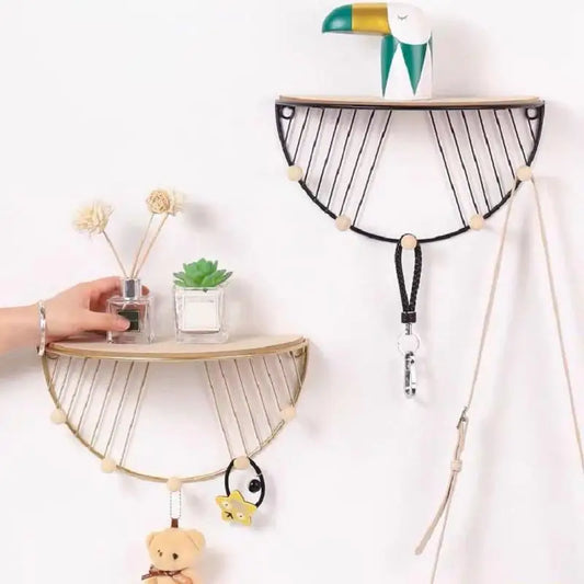 Set of two floating wall shelf for decor with wooden tops and black and gold wire frames holding small plants and accessories