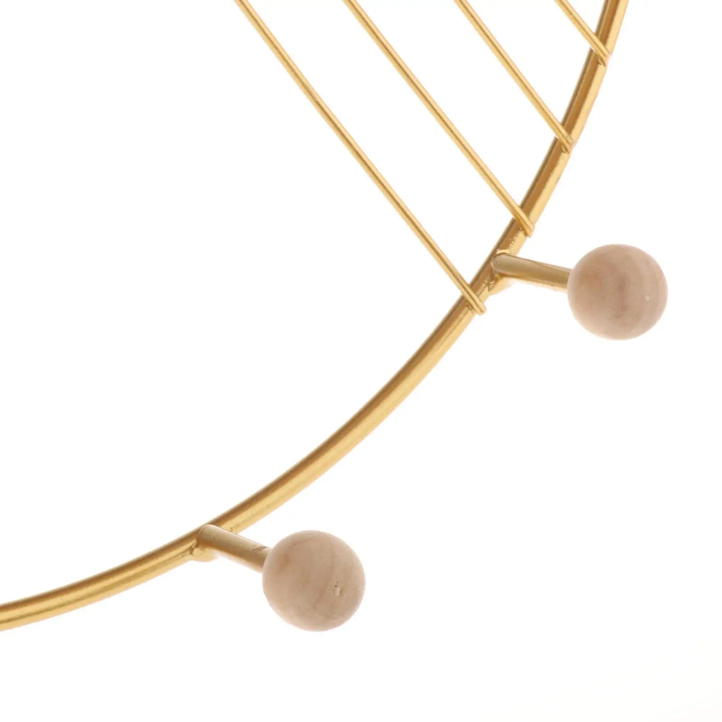 Close-up of gold metal and wooden hooks on floating wall shelf for decor by Clarify.pk