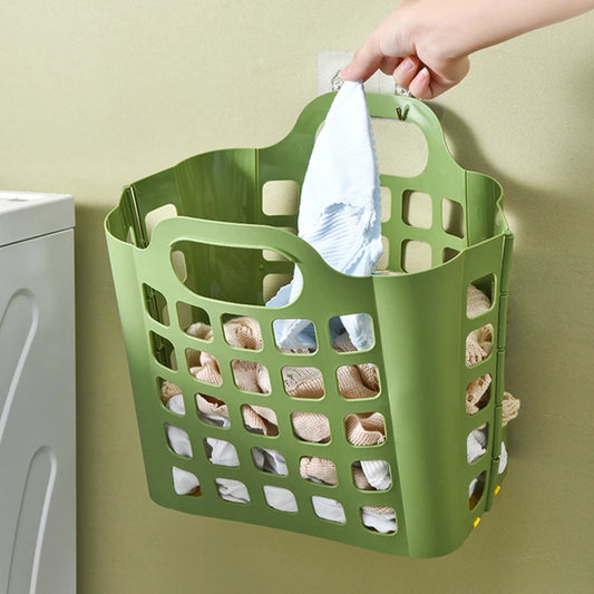 Green Clarify.pk foldable plastic laundry basket mounted on wall with clothes inside