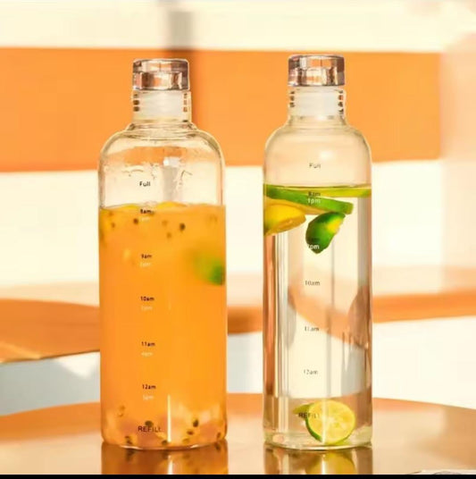 Two transparent plastic water bottle 500ml filled with lemon and passion fruit infused drinks on a reflective surface