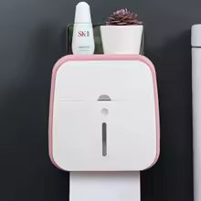 Clarify.pk wall mounted bathroom organizer in white with pink edges holding skincare items and a small plant
