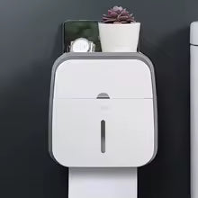 Clarify.pk wall mounted bathroom organizer in white holding small items and a plant on top