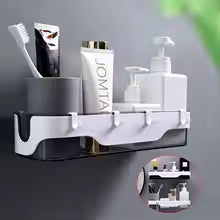 Wall-mounted bathroom shelf by Clarify.pk holding toothbrush, toothpaste, and soap dispenser