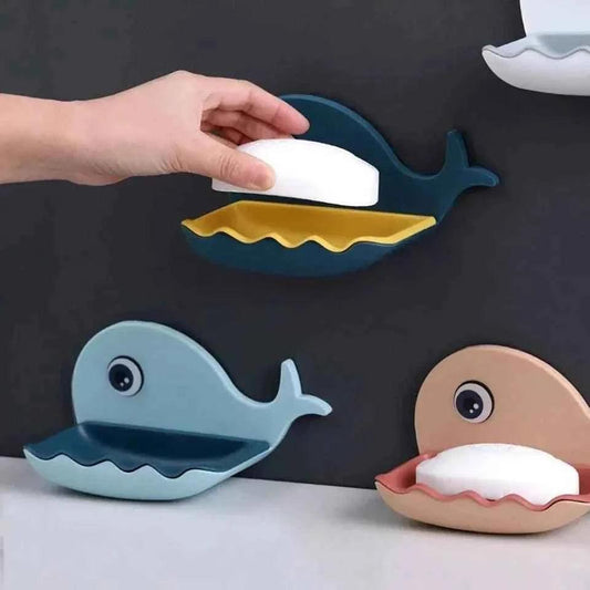 Clarify wall mounted fish soap dish in blue, teal, and beige holding bars of soap on bathroom wall