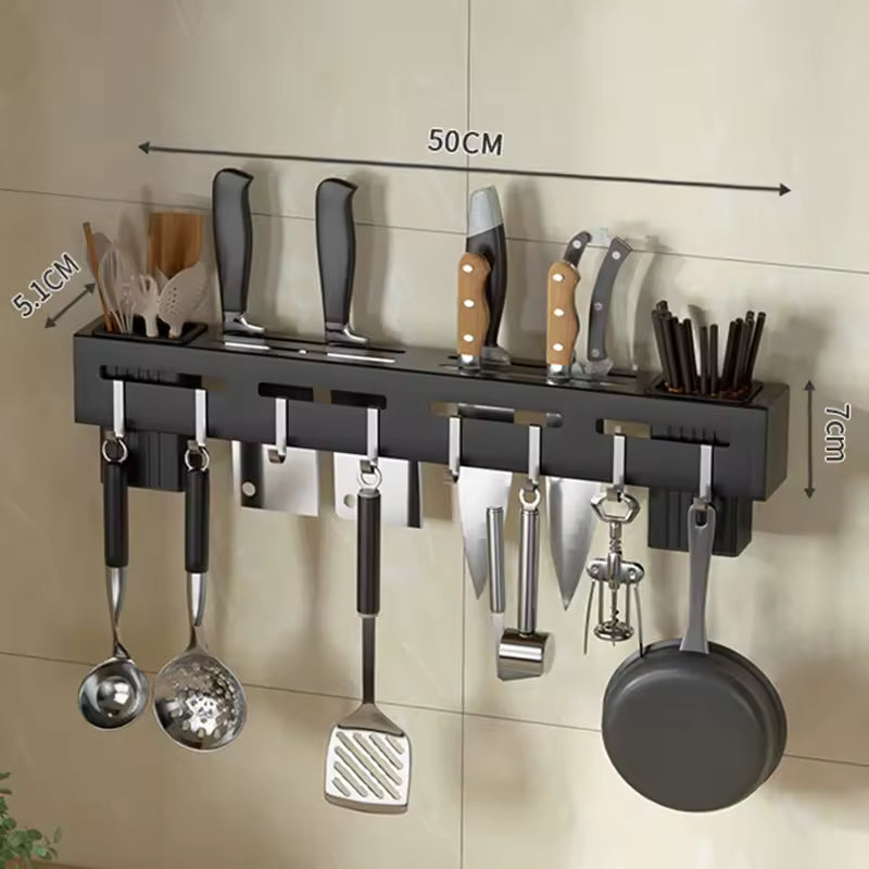 Black wall mounted knife holder with knives, utensils, and hooks for hanging kitchen tools