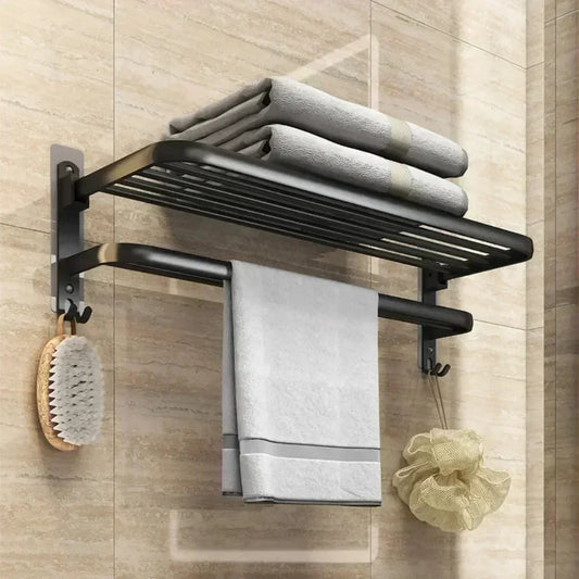 Black wall mounted shower towel rack with shelf holding folded towels and hanging bath accessories