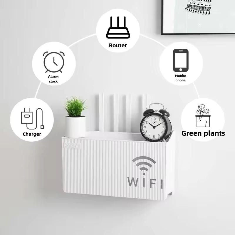 Clarify.pk wall mounted wifi router box in white holding router, alarm clock, charger, mobile phone, and green plants