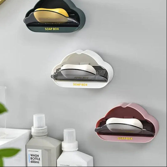 Whimsical cloud soap dish in black white and pink mounted on wall holding soap bars