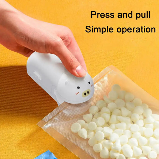 White pig-shaped handheld food sealing device sealing a plastic bag with white snacks inside