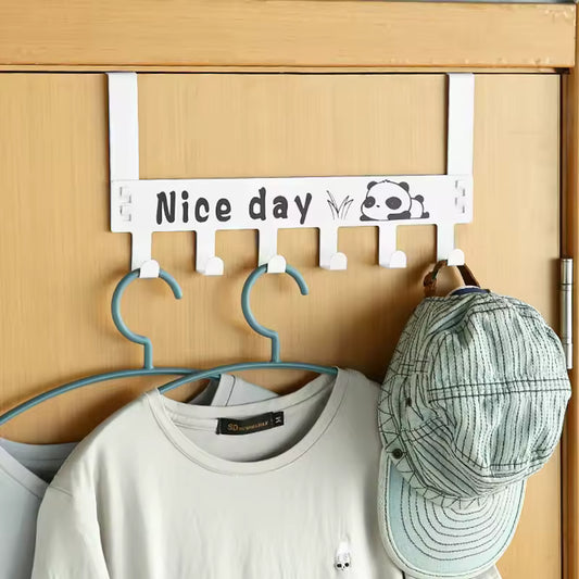 White over the door hanger rack with Nice day text and panda design holding clothes and a cap