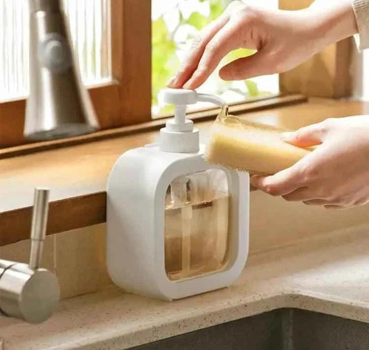 White Square Soap Dispenser mounted on kitchen counter being used to dispense soap onto a sponge