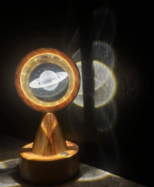 Clarify.pk crystal globe projector lamp displaying illuminated Saturn planet with wooden base and ambient light projection