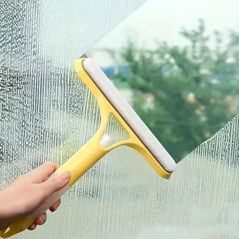 Yellow 3-in-1 shower scraper cleaning water and soap scum off a glass window
