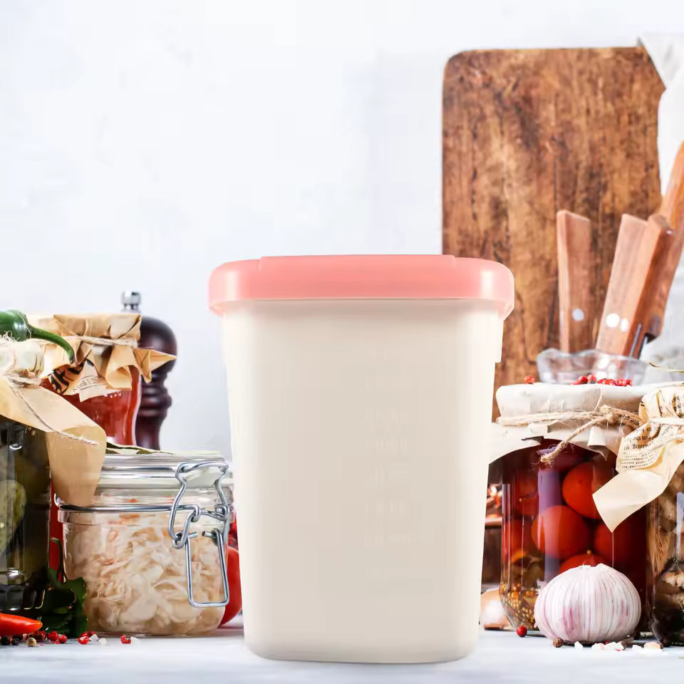 10kg rice storage container with pink lid placed on kitchen counter surrounded by preserved jars and garlic
