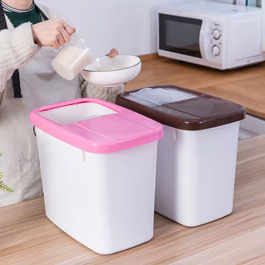 Two 10kg rice storage containers with pink and brown lids on kitchen counter being used to scoop rice