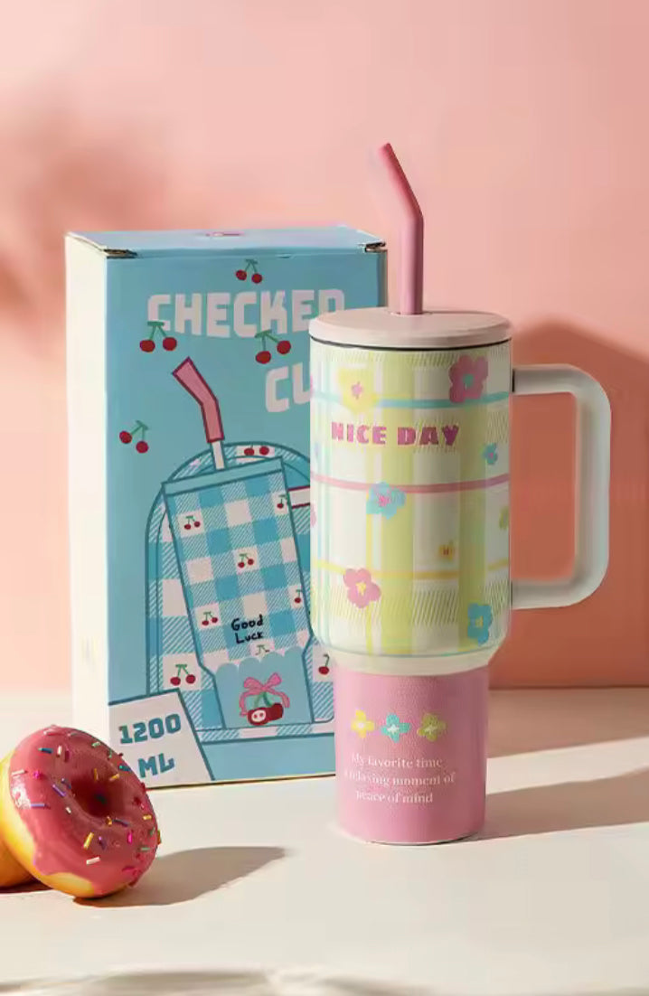 1200ml stainless steel tumbler with floral and checkered design, pink lid and straw, and a handle