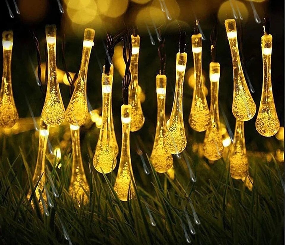 20 bulb decorative fairy lights for home with warm yellow teardrop-shaped bulbs glowing outdoors