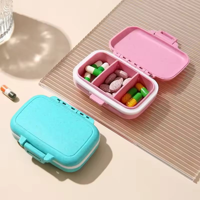 3 compartment pill box by Clarify.pk in pink and blue with pills inside and secure latch