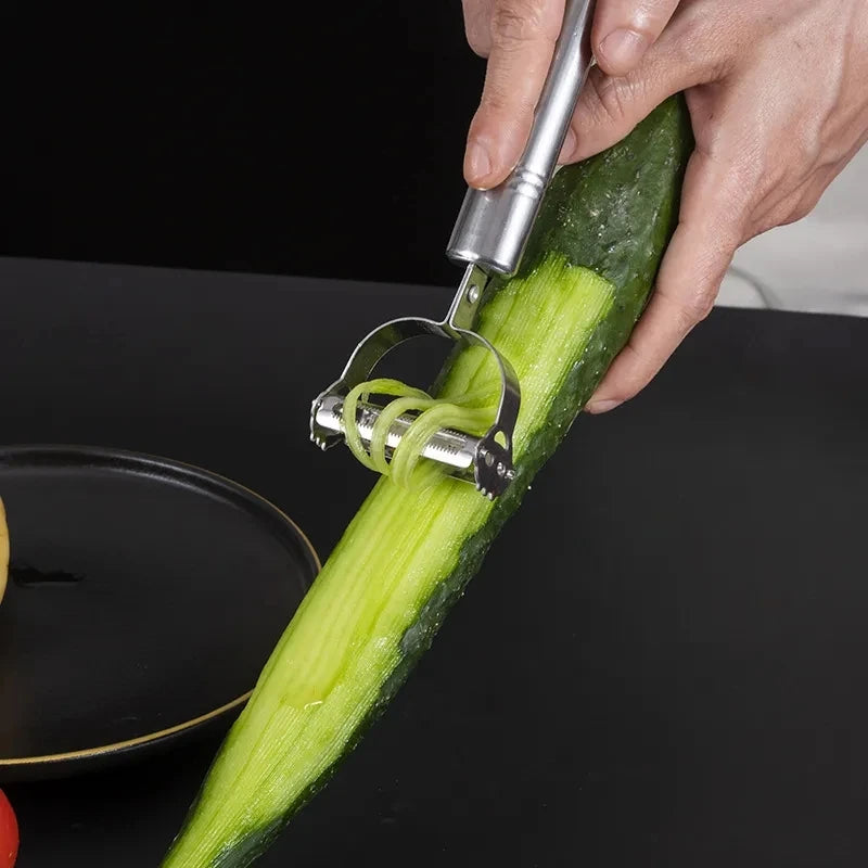 3 in 1 kitchen peeler and grater peeling a cucumber for easy vegetable preparation