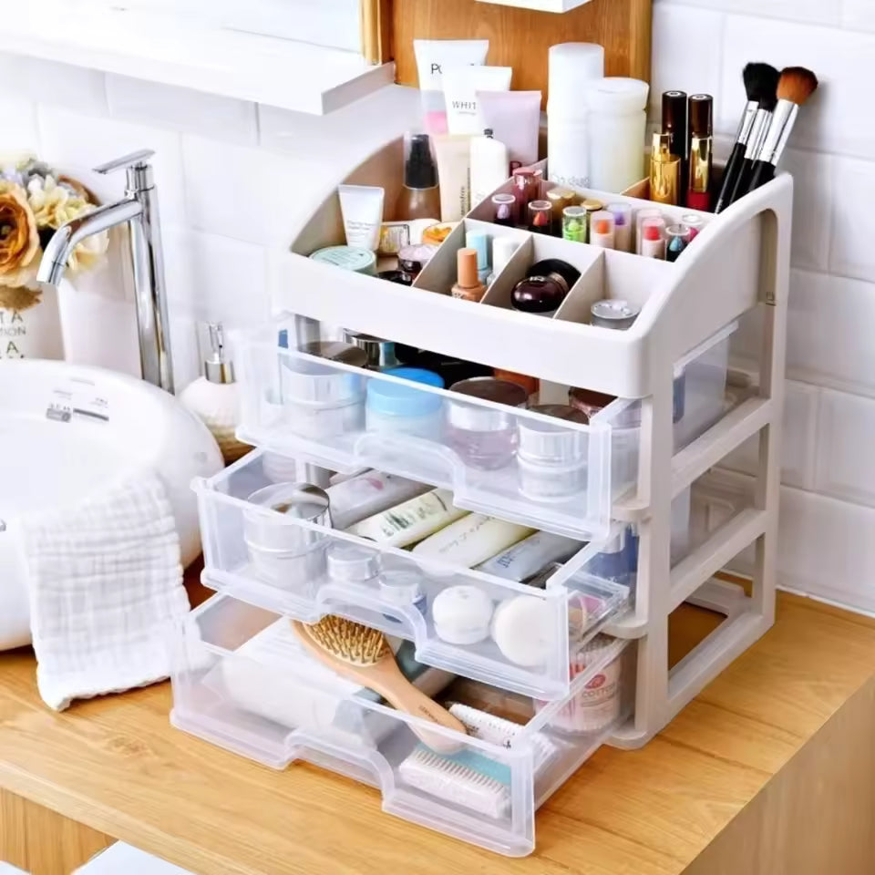 3 layer cosmetic storage case on wooden bathroom counter organized with makeup brushes lipsticks and skincare products