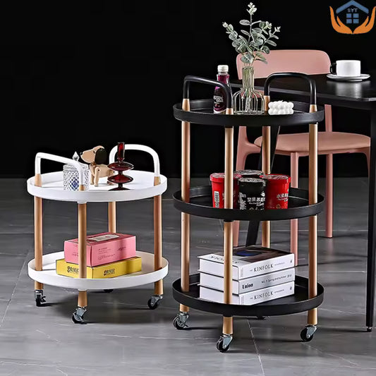 Clarify.pk 3 tier rotating cart in black and white with gold legs on wheels holding books and decor