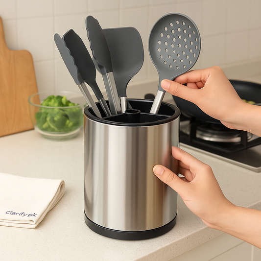 360 rotating kitchen utensil holder in stainless steel with black silicone handles organized on kitchen counter