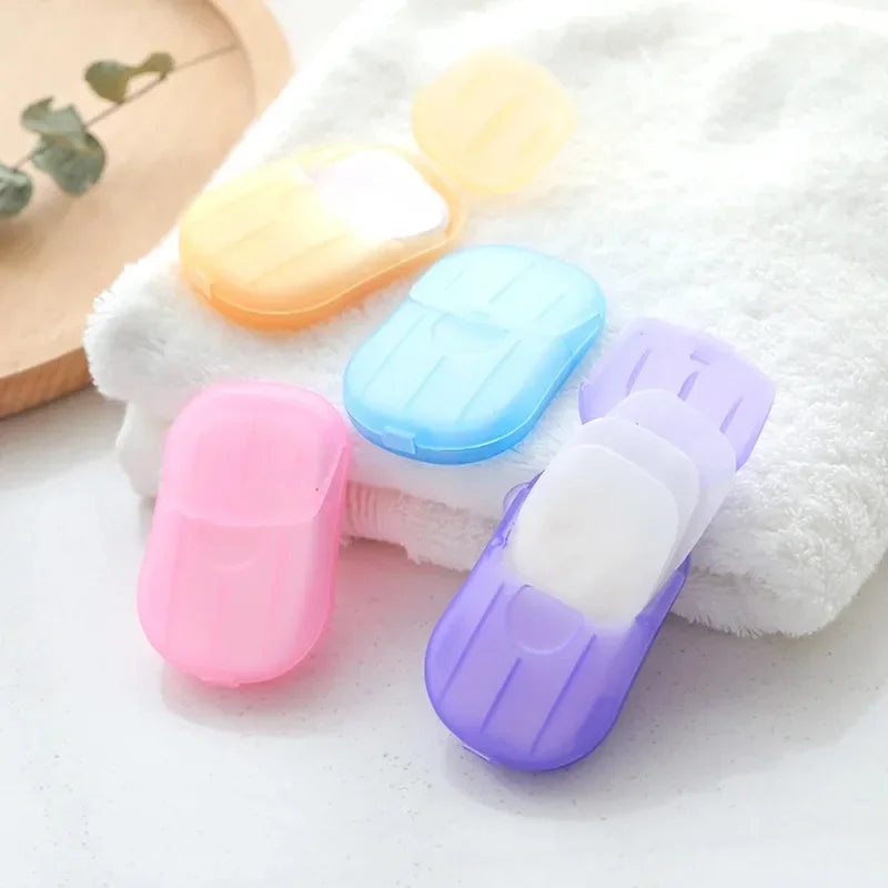 4 box travel soap paper sheets in colorful compact cases on white towel for convenient use