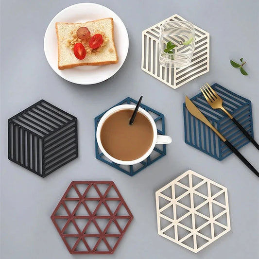 Set of 4 pieces heat resistant silicone dining mat in various colors with coffee, toast, and utensils on gray surface