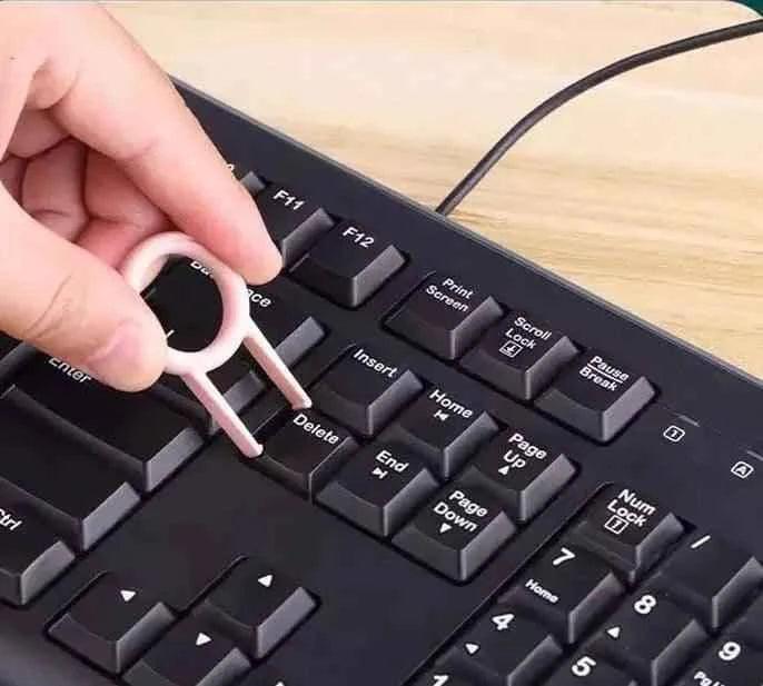 Clarify 7 in 1 keyboard cleaning kit used to remove keycaps from a black computer keyboard