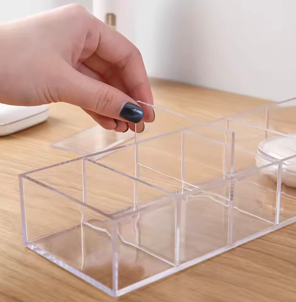 Clear plastic 8 compartment organizer on wooden surface with hand placing divider by Clarify.pk