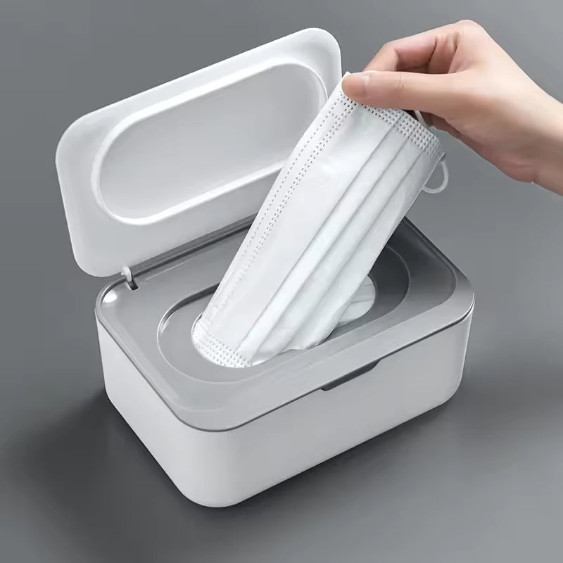 Clarify.pk white wet wipes dispenser with lid holding a hand placing a face mask inside