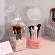 Clear acrylic cosmetic organizer holding makeup brushes with pink bead fillers for storage