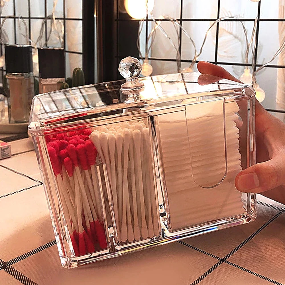 Clear acrylic cotton swab box with compartments holding red and white swabs and cotton pads