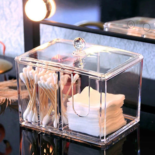 Clear acrylic cotton swab box with two compartments holding cotton swabs and cotton pads