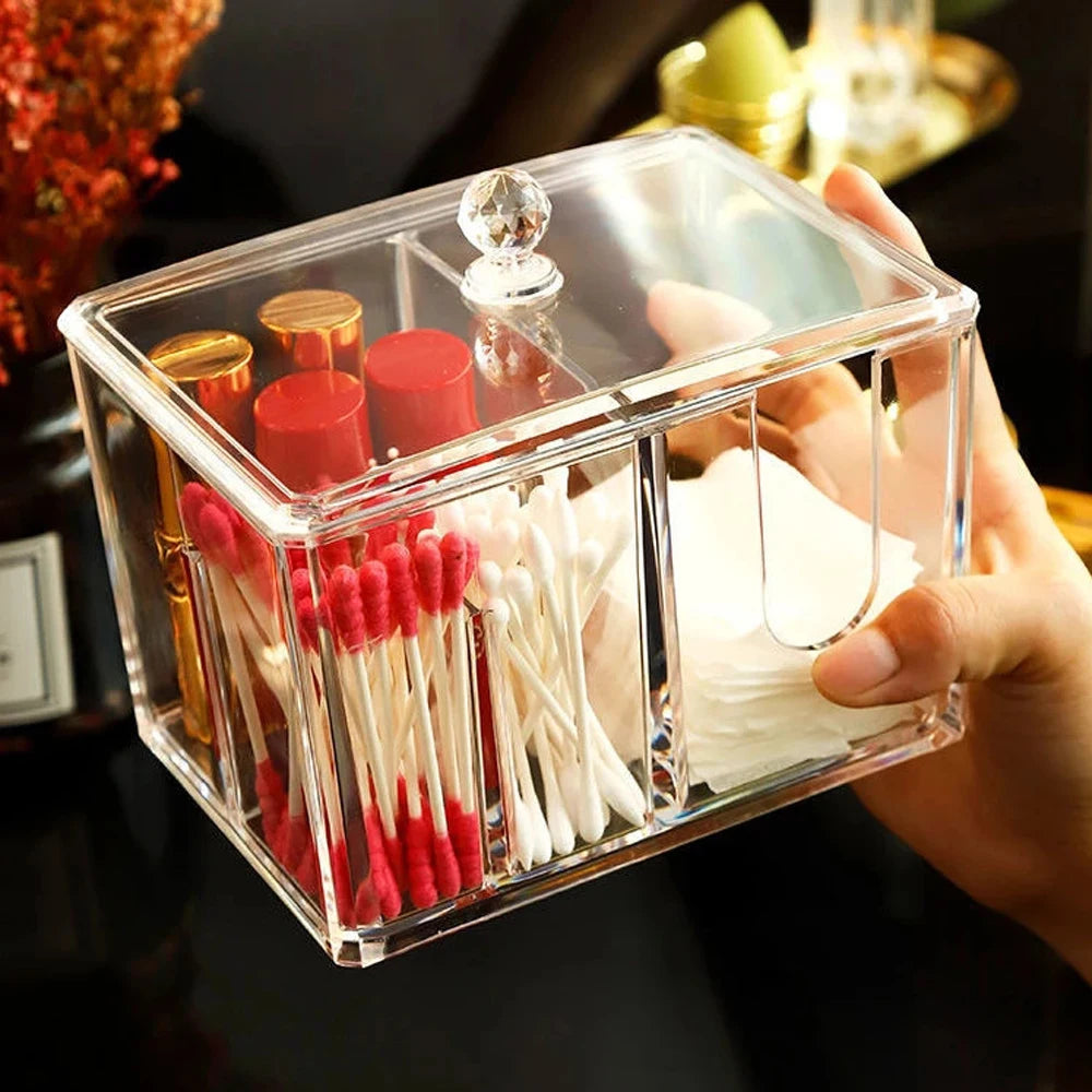 Clear acrylic cotton swab box with multiple compartments holding cotton swabs and makeup items